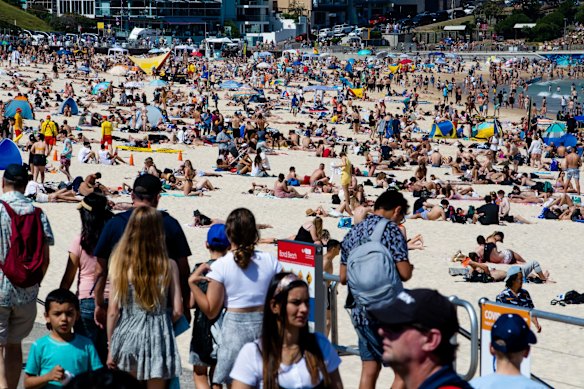 People enjoying the long weekend at Bondi Beach, the carpark busy but not closed.