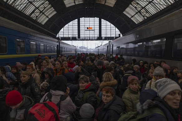  Families make their way from the main train terminal in Lviv, Ukraine.  