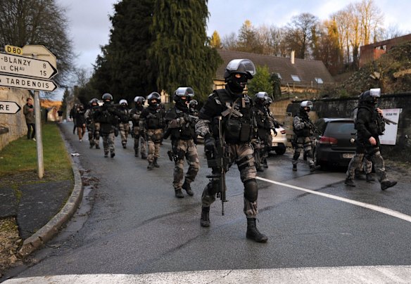 Manhunt: French police special forces on patrol in Corcy in northern Franse.
