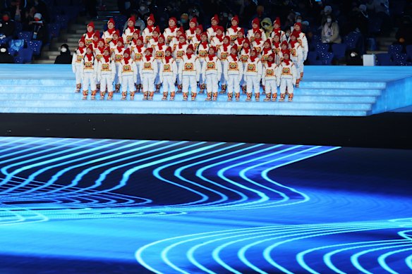 Performers sing the Olympic anthem during the Opening Ceremony.