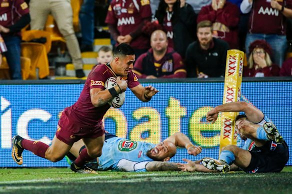 Valentine Holmes of the Maroons scores a try.