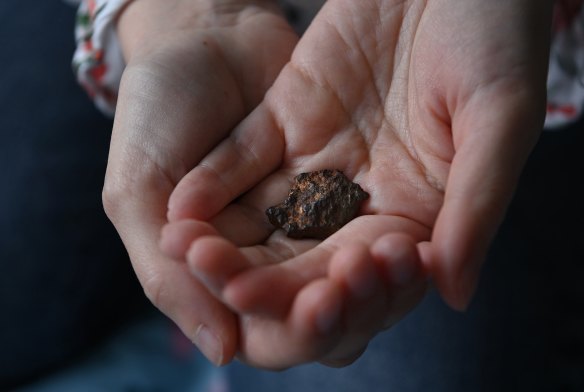 Now living in Sydney, Anna-Mariia Mykytiuk holds the fragment of a cluster bomb that flew past her head.