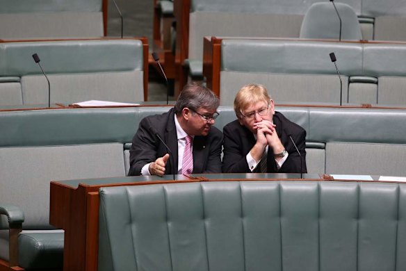 Gary Gray and Martin Ferguson talk after question time at Parliament House.
