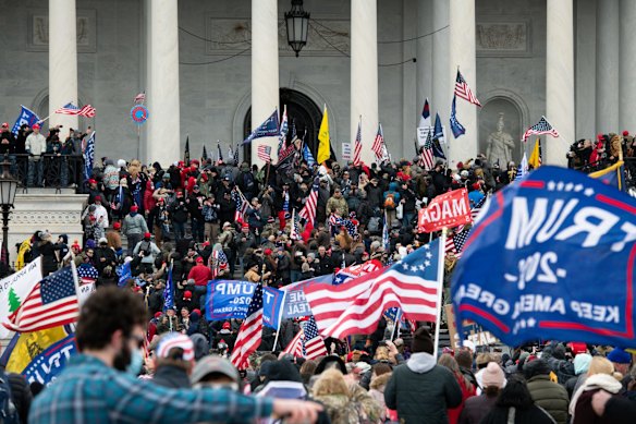 Demonstrators enter the US Capitol after breaching security fencing.