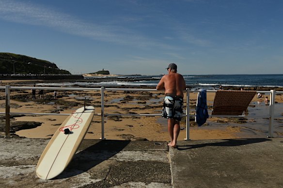 People dry off after a swim, near the ocean baths at Newcastle, as temperatures rise during lockdown.
