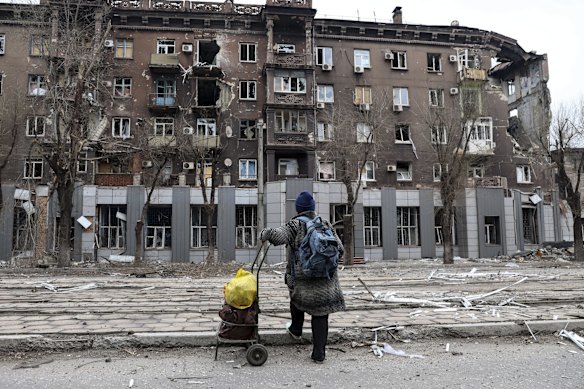 A local resident looks at a damaged during a heavy fighting apartment building near the Illich Iron &  Steel Works Metallurgical Plant, the second largest metallurgical enterprise in Ukraine, in an area controlled by Russian-backed separatist forces in Mariupol, Ukraine.