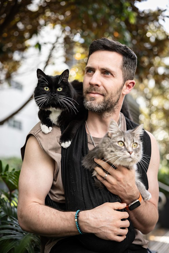 Greg Beazley with cats Pom Pom and Bewty.