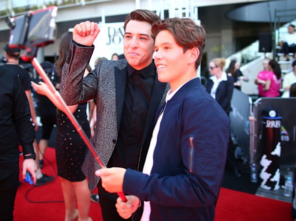 Taylor Henderson and Jai Waetford take a selfie on the red carpet.
