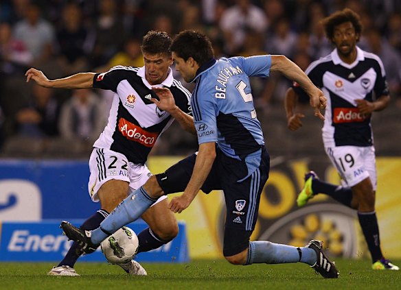 Michael Beauchamp of Sydney tackles Harry Kewell of the Victory during the round one A-League match between Melbourne Victory and Sydney FC at Etihad Stadium on October 8, 2011 in Melbourne, Australia.