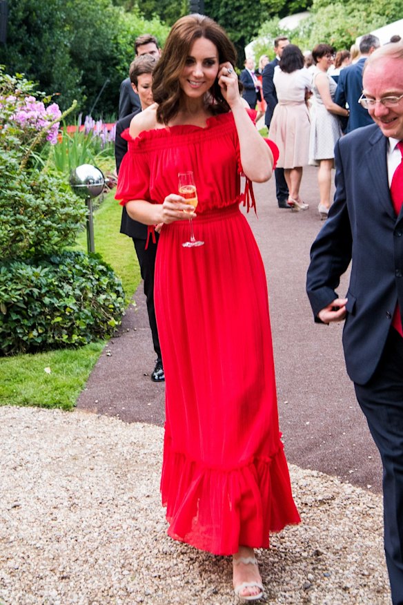 July 19: The Duchess gave the cold shoulder while attending The Queen's Birthday Party at the British Ambassadorial Residence on the first day of their visit to Germany. She wore an off-the-shoulder Alexander McQueen maxi  with a tiered ruffled hem with Prada wavy strap sandals. Her drop earrings were by Simone Rocha.