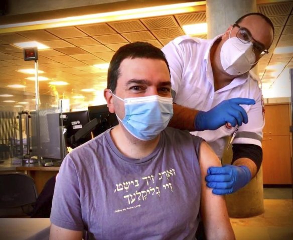 Ittay Flescher, 40, from Melbourne receiving the Pfizer vaccine in Israel.