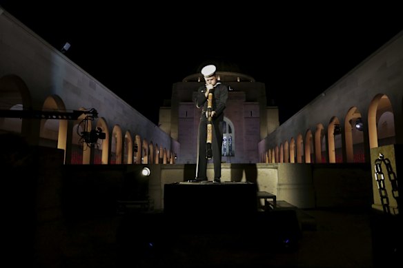 Gamilaraay man Seaman Lynton Robbins plays the didgeridoo during the Anzac Day commemorative service at the Australian War Memorial in Canberra.