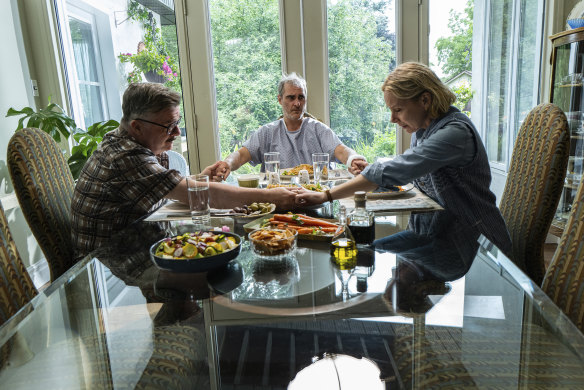 Nathan Lane, from left, Joaquin Phoenix and Amy Ryan in a scene from “Beau is Afraid.” 