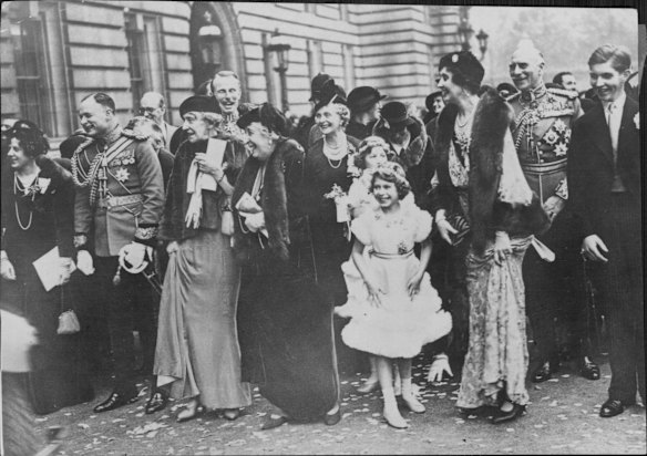 Royal wedding guests, assembled in the forecourt of Buckingham Palace, bid farewell to the Duke and Duchess of Gloucester as they drive to S. Pancras Station.
L to R: Lady Maud Carnegie, the Marquess of Cambridge, Princess Marie Louise (behind whom is Lord Carnegie), Princess Helena Victoria, the Countess of Athlane, Princess Elizabeth and behind her, Lady Mary Cambridge, Lady Patricia Ramsay, the Earl of Athlone, and Mr A. Ramsay.  November 6, 1935. 

