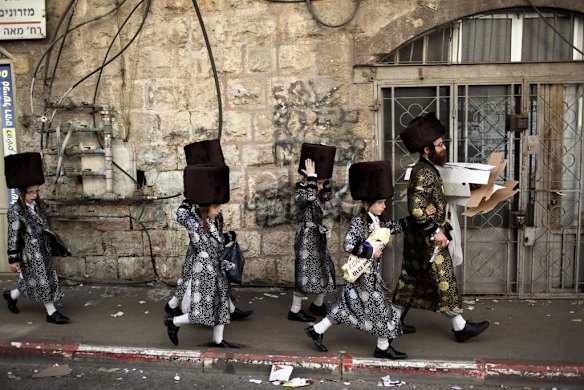 An Ultra Orthodox Jewish family walk during the Purim.