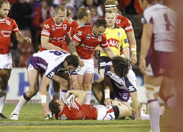 Dragons Brett Morris lays on the ground after being speared by Storm players.