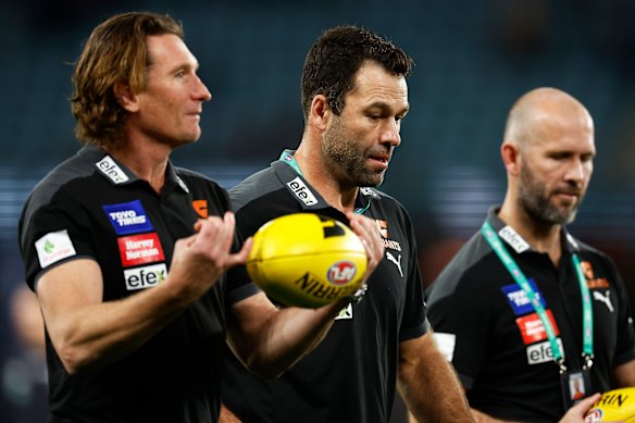 Back then: James Hird and Dean Solomon speak with then Giants interim coach Mark McVeigh during the 2022 season. Hird and McVeigh are now seeking to coach the Bombers, while Solomon is yet to indicate his intentions.