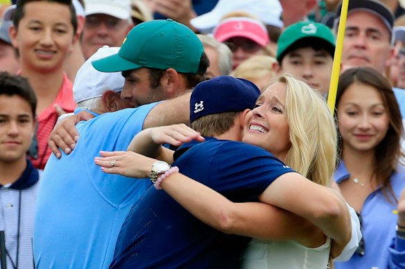 Jordan Spieth is greeted by his family behind the 18th green.