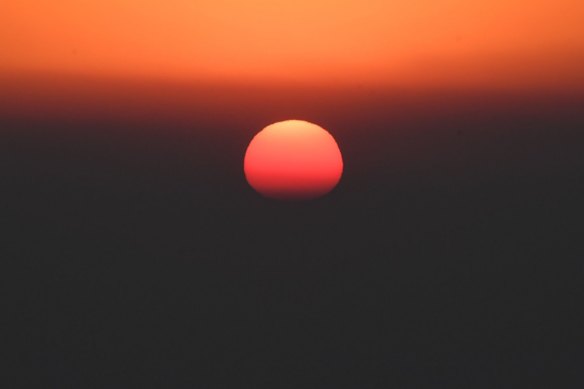 Smoke causes a crimson sunrise this morning.