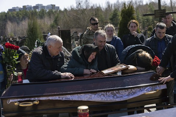 Relatives mourn the death of Oleksandr Mozheiko, 31, a territorial defence soldier who was killed by the Russian army on March 5, during his funeral in Irpin, on the outskirts of Kyiv.