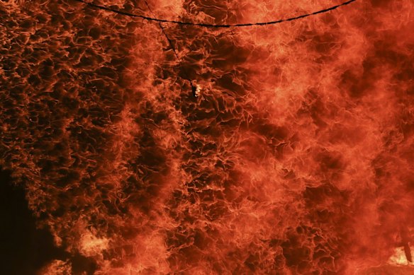 A horse stable burns as a bushfire burning south of Canberra threatens communities in Bumbalong.