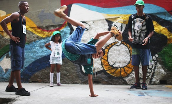 A competitor warms up ahead of the Passinho battle during celebrations marking Day of the Favela in the Madureira favela community.
