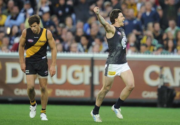 Richmond's Alex Rance shattered after Carlton's Nick Duigan celebrates his goal.