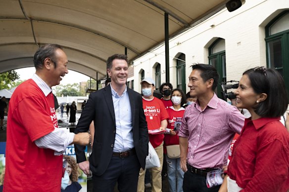 NSW Labor leader Chris Minns (second from left) and NSW Labor candidate for Strathfield Jason Yat-sen Li  (second from right) at Burwood Public School polling booth.
