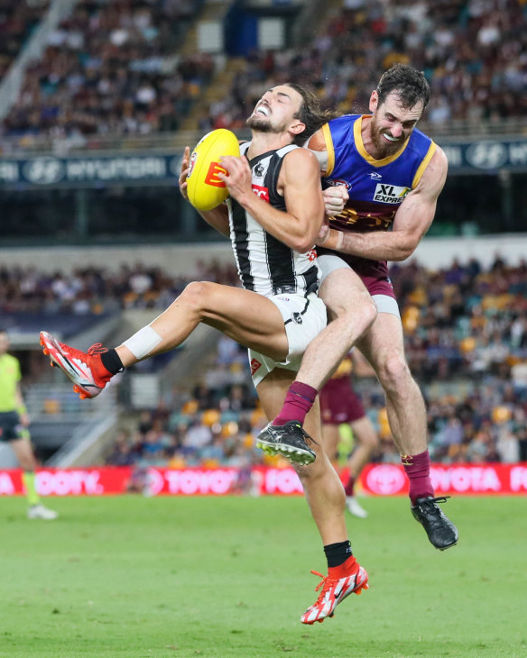 Josh Daicos is cleaned up by Darcy Gardiner after taking a mark.