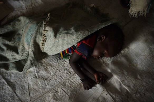 A baby sleeps on the floor inside the CARE nutrition clinic at sector 5 inside the UN Bentiu Protection of Civilians (POC) site, Bentiu, Unity State, South Sudan. 