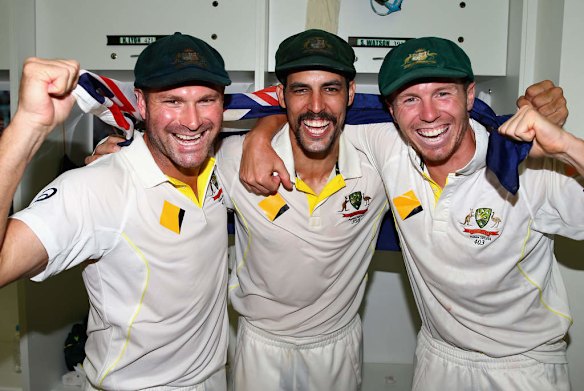 Ryan Harris, Mitchell Johnson and Peter Siddle of Australia celebrate victory in the change rooms.