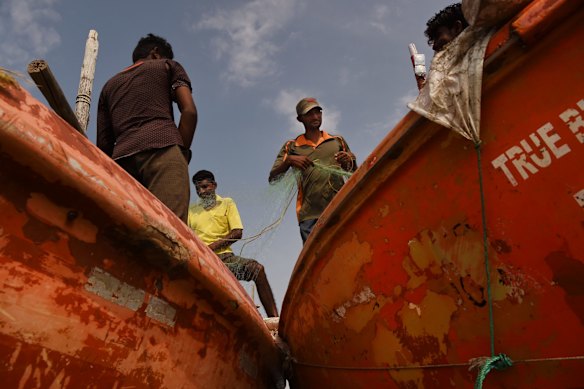 Traditional fishermen from Tragadi Bandar unravel their nets on the Kutch coast in Gujarat state, India. Community leader, Budha Ismael, says that passing tankers from the nearby Adani operations destroy their nets and have disturbed their fishing grounds. 