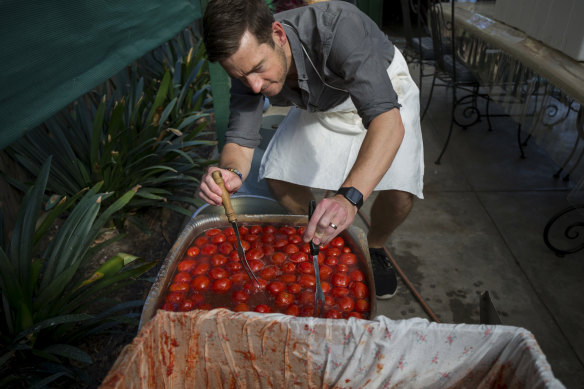 Nathan Jones helps prepare the passata tomatoes.