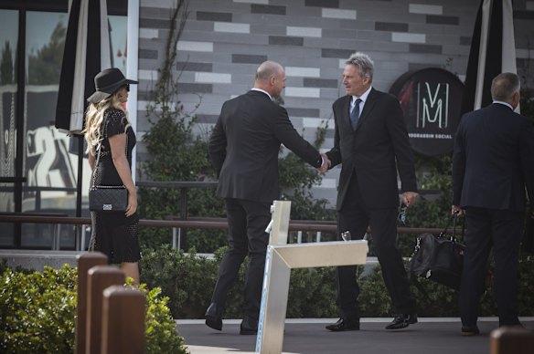 Sam Newman (right) greets former St Kilda footballer Aaron Hamill.