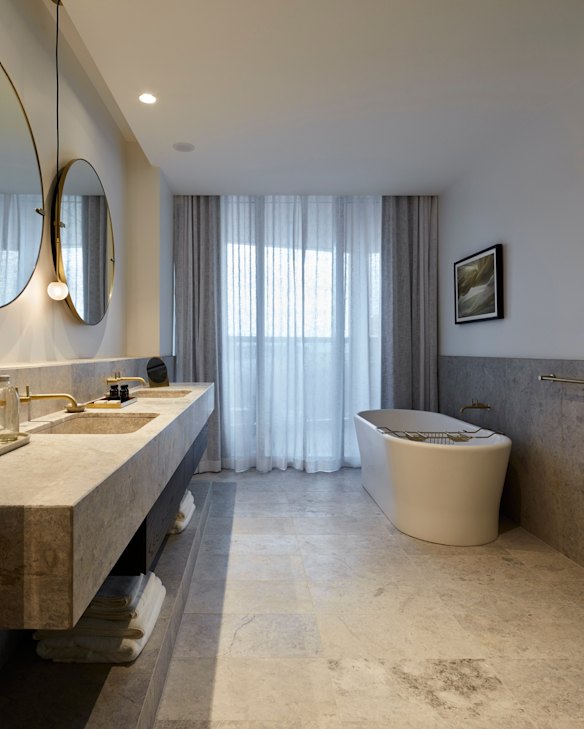 Radiance River View Suite's marble bathroom with bathtub.