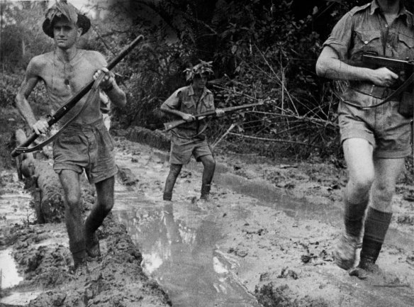 
Australian troops plough through the mud at Milne Bay after repulsing the Japanese invasion attempt.