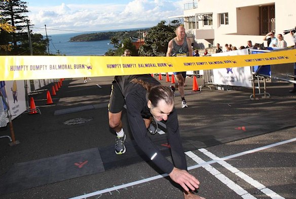 The Humpty Dumpty Foundation's Balmoral Burn run. Todd Devery, winner of the Male/female aged 50-59, crawls under the finishing banner.