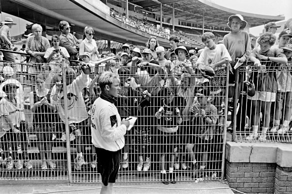 Warne signs autographs during a match between NSW and Victoria at the SCG in December 1993. 