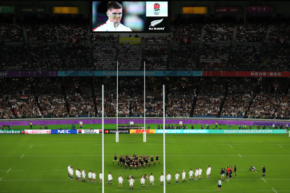   Owen Farrell is seen smiling on the big screen during the haka.
