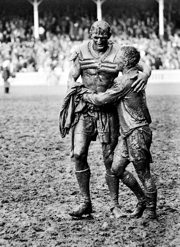 Camaraderie follows conflict: Norm Provan, of St George, and Wests' Arthur Summons leave the Sydney Cricket Ground together after the 1963 rugby league grand final, won by Saints. It is the inspiration for the current NRL premiership trophy.