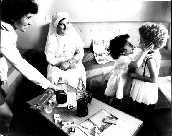 Maris Baikas (smaller girl) greets her sister Irene with a big kiss at hotel. Her mother, Cathy Baikas & Sister Mary Laurence look on. March 8, 1973. 