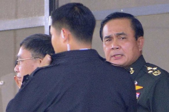 Thailand's army chief General Prayuth Chan-ocha (right) leaves the Army Club.