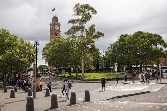Hundreds wait in a line for a COVID-19 PCR test that snakes through and around Central Station and down to Eddy Avenue in Sydney's CBD on Tuesday, December 28, 2021.