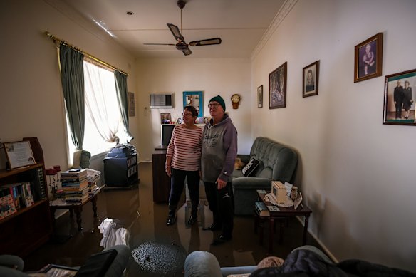 Glenys and Brian in their flooded lounge room.