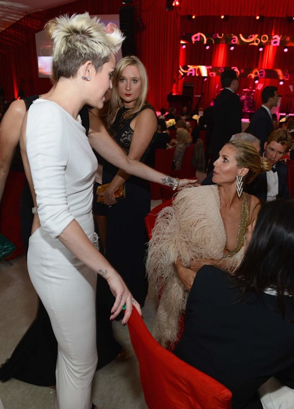 (L-R) Actress/singer Miley Cyrus and model Heidi Klum attend the 21st Annual Elton John AIDS Foundation Academy Awards Viewing Party.