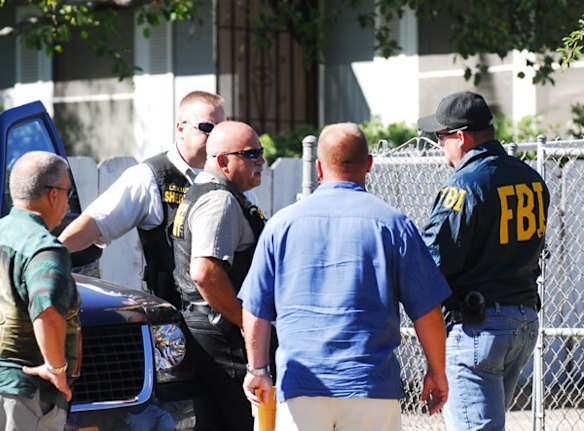 FBI agents and deputies from the Contra Costa County Sheriff's department talk in front of the house where an Phillip and Nancy Garrido were taken into custody.