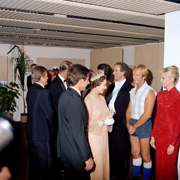 Queen Elizabeth II and the Duke of Edinburgh meet entertainers including Paul Hogan who performed in a 1980 Royal Charity Concert at the Opera House.