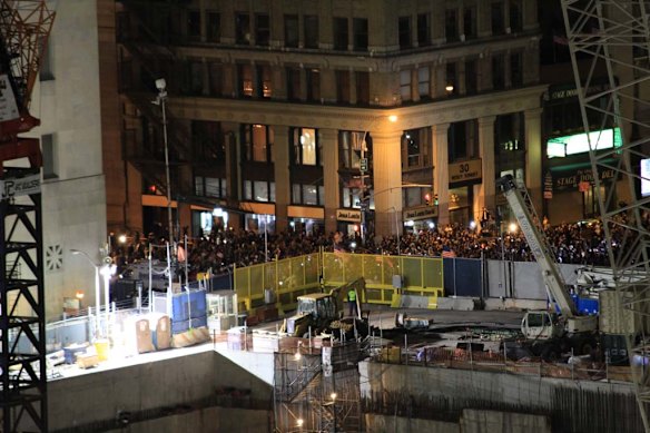 Crowds gather in Manhattan at Ground Zero - the site where the Twin Towers were destroyed in a terrorist attack on 9/11.