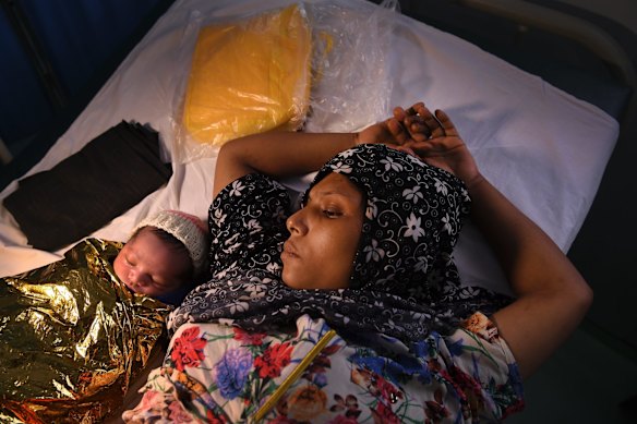 Fatima aged 25 years (right) lays next to her hours old baby at the Medecins Sans Frontieres hospital in Kutupalong Camp. MSF are delivering babies, treating many people with respiratory tract infections & diarrhoea due to the living conditions in the camps and the monsoon rains.