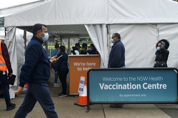 Long lines outside the COVID-19 vaccination centre at Olympic Park as COVID-19 lockdown stretches on across Greater Sydney.